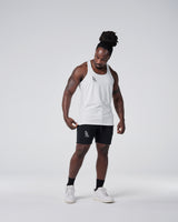 Head-to-toe look with white gym stringer and black shorts.