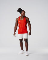 Head-to-toe look with red gym stringer and light grey shorts.
