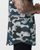 Detailed hem tag view of Limitless sleeveless blue camo tank, stitched with signature slogan.