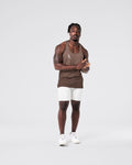 Full body fit of brown gym stringer and light grey shorts.