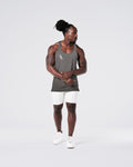 Head-to-toe look with grey gym stringer and light grey shorts.