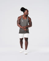 Head-to-toe look with grey gym stringer and light grey shorts.