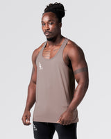 Mesh-paneled athletic tank left side profile in rose. 