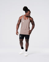 Head-to-toe look with gym stringer in rose and shorts in black. 