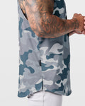 Detailed hem tag view of Limitless sleeveless grey camo tank, stitched with signature slogan.