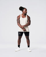 Head-to-toe look with off-white gym stringer and black shorts. 