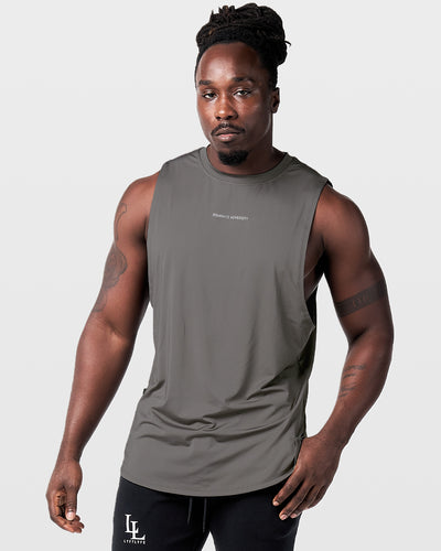 Mens sleeveless tank top in dark grey with a reflective Dominate Adversity logo at center chest.