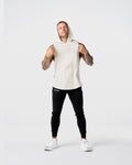 Front view of Limitless Men’s Sleeveless Hoodie in off-white with hood, split hem, and reflective chest logo.