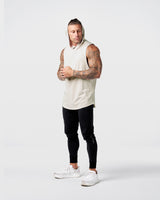 Side view of Limitless Men’s Sleeveless Hoodie in off-white with hood, split hem, and reflective chest logo.