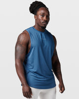 Right side view of dark blue sleeveless gym tank, showing relaxed fit and ergonomic armhole design.