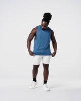 Limitless Men’s Cut Sleeve in dark blue, with reflective chest logo, scalloped hem, and wide shoulder cut.