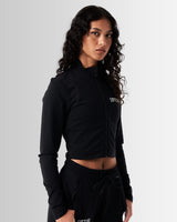 Left Side view of Breathe Women’s Zip-Up Crop in black, highlighting the ergonomic fit, custom zipper closure, and breathable fabric.