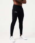 Right Side view of black men’s joggers with a reflective logo near the pocket and stretch fabric for optimal movement.