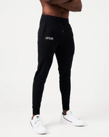 Right Side view of black men’s joggers with a reflective logo near the pocket and stretch fabric for optimal movement.