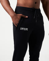 Close-up of men’s black Breathe Joggers, highlighting the invisible side pocket with locking zipper and Lyftlyfe reflective logo.