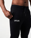 Close-up of men’s black Breathe Joggers, highlighting the invisible side pocket with locking zipper and Lyftlyfe reflective logo.