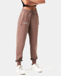 Side view of Women’s lightweight joggers in brown,  highlighting moisture-wicking fabric, thick waistband, and ergonomic fit for comfort.