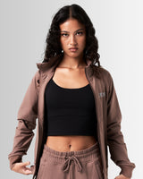 Women's performance zip-up jacket in brown, crafted from moisture-wicking, lightweight fabric for mobility.