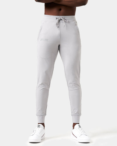 Light gray sweatpants with a brand logo on a white background