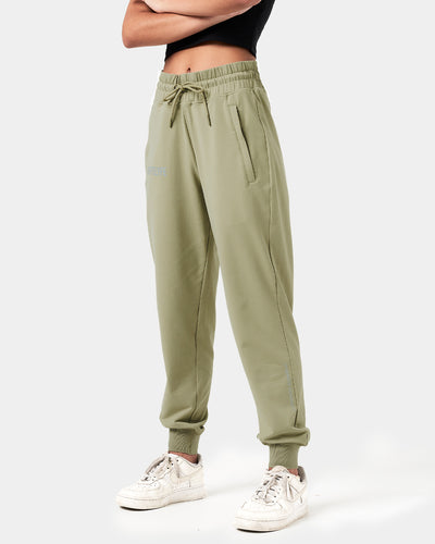 Front view of women’s green Breathe Joggers with a reflective Lyftlyfe logo, thick waistband, and tapered fit for a flattering look.