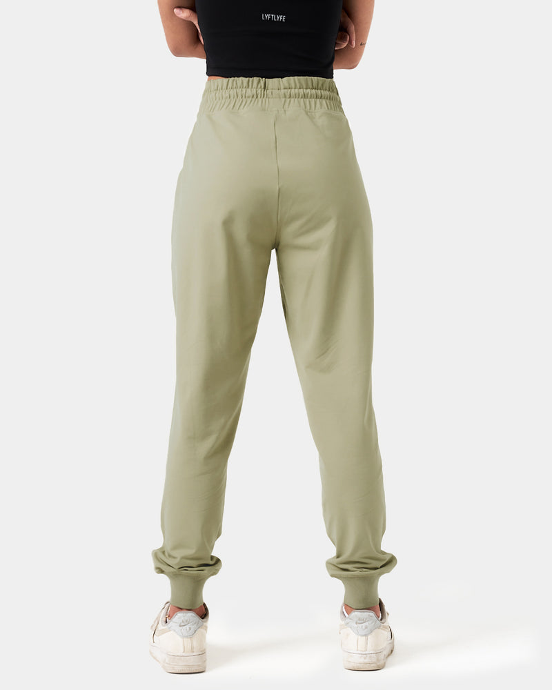Women’s green joggers shown from the back, designed with a focus on comfort, breathability, and performance.