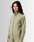 Women’s performance zip-up jacket in green, side profile showcasing breathable material and functional locking zipper pocket.