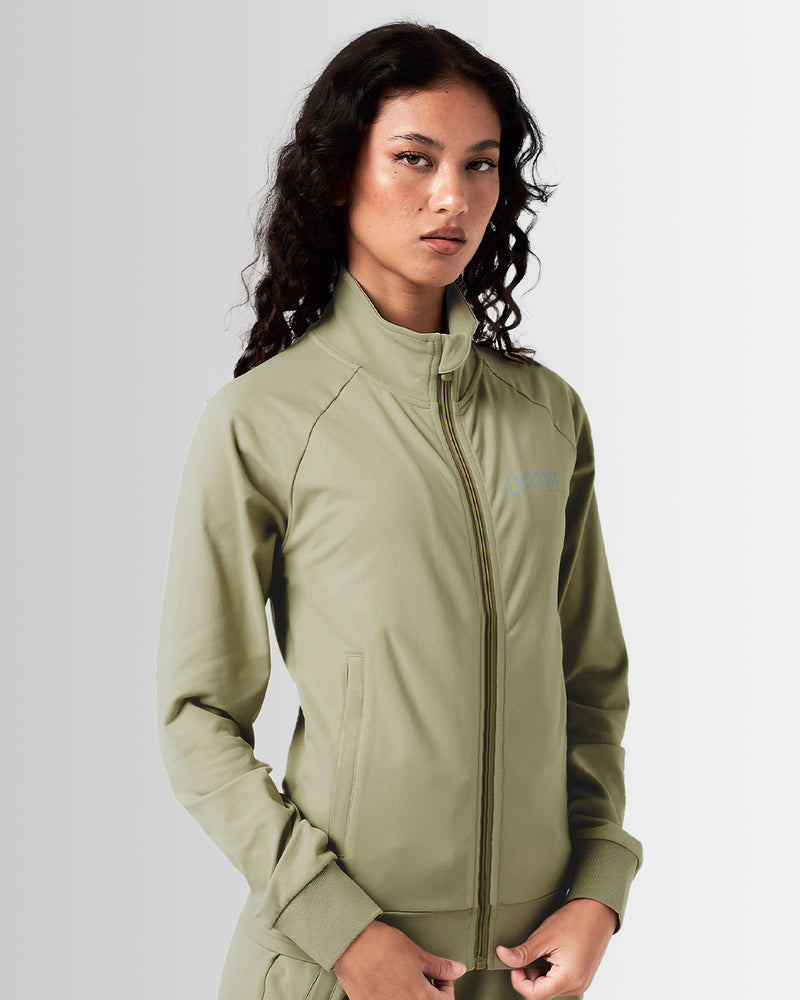 Women’s green Breathe Zip-Up Jacket featuring a minimalist reflective Lyftlyfe logo on the left chest and a streamlined, athletic fit.