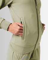 Close-up of the secure invisible pocket with locking zipper on women’s green Breathe Jacket, showcasing functional design and sleek finish.