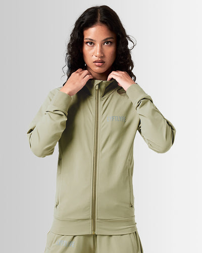 Women’s green Breathe Zip-Up Jacket featuring a minimalist reflective Lyftlyfe logo on the left chest and a streamlined, athletic fit.