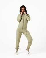 Women’s Breathe Zip-Up Jacket in green, designed for comfort and performance with a sleek fit and reflective branding.