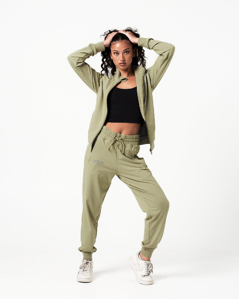 Women’s green Breathe Zip-Up Jacket featuring a minimalist reflective Lyftlyfe logo on the left chest and a streamlined, athletic fit.