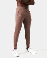 Right side view of brown men’s joggers with a reflective logo near the right pocket and stretch fabric for optimal movement.