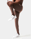 Side view of men’s brown Breathe Joggers with cuffed hems, 4-way stretch fabric, and ergonomic design for unrestricted movement.