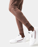 Close-up of the 'Dominate Adversity' slogan printed on the lower left leg of men’s brown Breathe Joggers.