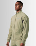 Left side view of men’s breathable zip-up jacket in green, highlighting sweat-wicking properties and tonal stitching.