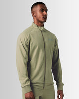 Right side view of men’s breathable zip-up jacket in green, highlighting sweat-wicking properties and tonal stitching.