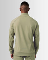 Back profile of men’s green athletic zip-up jacket featuring 4-way stretch material and tailored fit for optimal mobility.