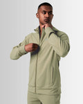 Side view of men’s green Breathe Zip-Up Jacket with ergonomic fit, wide cuffs, and lightweight stretch fabric for maximum performance. 