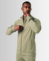 Side view of men’s green Breathe Zip-Up Jacket with ergonomic fit, wide cuffs, and lightweight stretch fabric for maximum performance. 