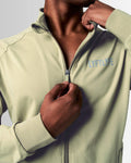 Detailed view of the neck and custom zipper construction on men’s sleek green zip-up jacket.