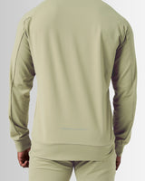 Back view of the men’s Breathe Zip-Up Jacket in green, featuring the 'Dominate Adversity' slogan printed at the lower back.