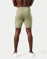 Back view of men’s breathable performance shorts in green with tapered design and durable moisture-wicking material.