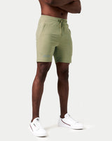 Side view of men’s green Breathe Shorts showcasing ergonomic design, moisture-wicking fabric, and secure zippered pocket.