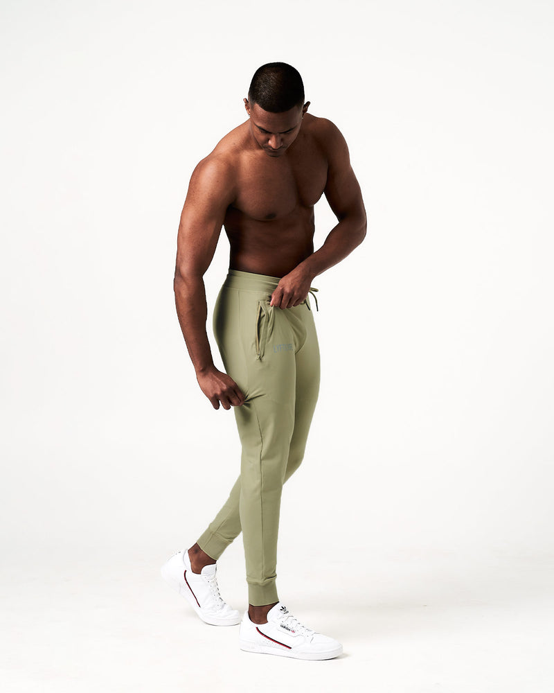 Light green sweatpants with a brand logo on a white background