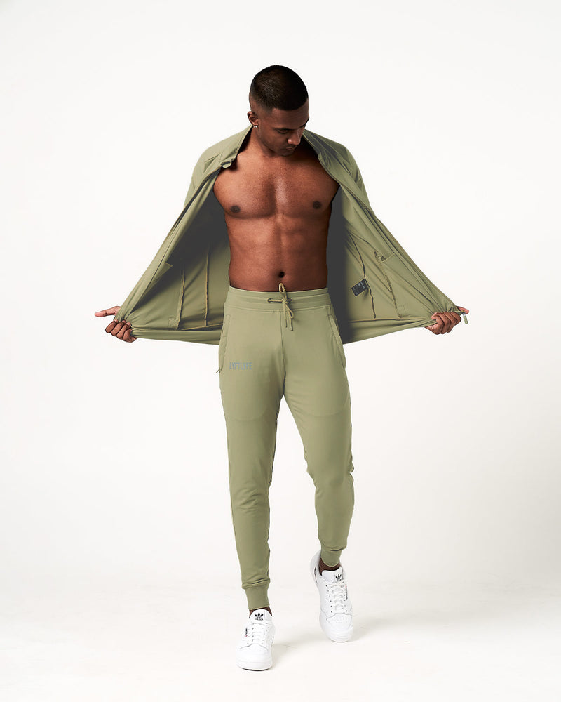 Light green sweatpants with a brand logo on a white background