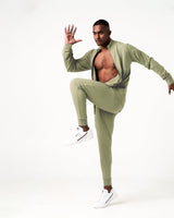 Side view of men’s green Breathe Joggers with cuffed hems, 4-way stretch fabric, and ergonomic design for unrestricted movement.