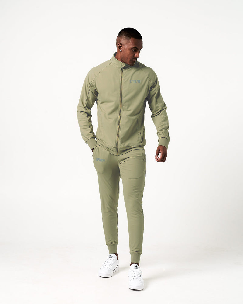 Light green sweatpants with a brand logo on a white background