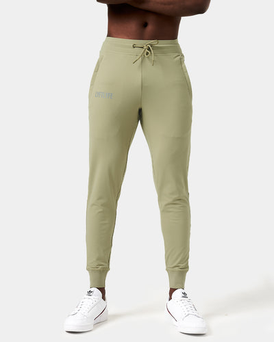 Light green sweatpants with a brand logo on a white background