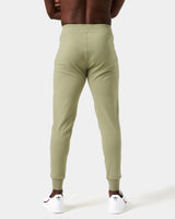 Men’s green joggers shown from the back, highlighting a relaxed fit and breathable, stretchy material for comfort.