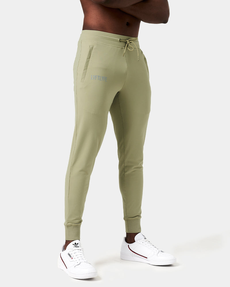 Light green sweatpants with a brand logo on a white background